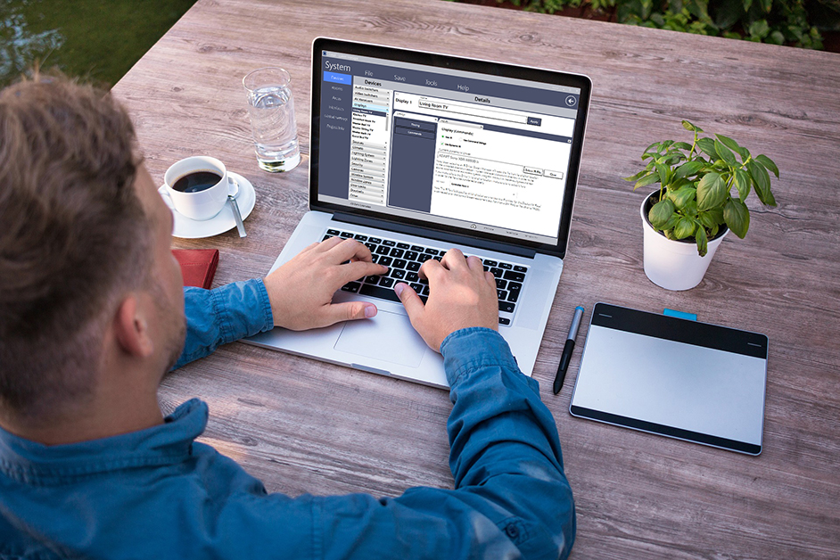 Man using Adapt System Manager application on laptop